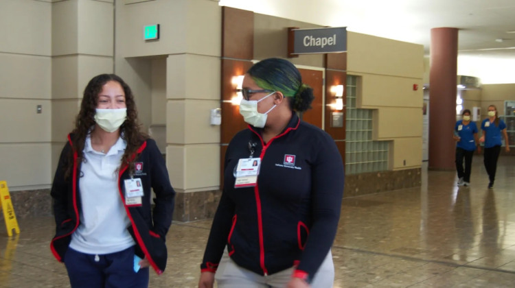 Aileen Reyes and Chandler Harris walk down a hallway at Methodist hospital on July 12, 2022. The two are enrolled in a program that gives students a glimpse into the health care field.   - Helen Rummel / Chalkbeat