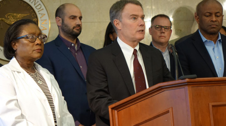 Marion County Public Health Director Virginia Caine, left, listens as Indianapolis Mayor Joe Hogsett explains why the city is closing all public schools on Thursday, March 12, 2020 at the City-County Building. - Eric Weddle/WFYI News