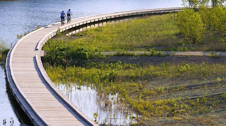 Residents enjoy a bike ride along the boardwalk in Carmel-Clay's Central Park. Hamilton County was ranked Indiana's healthiest county in a recent report. - Shutterstock