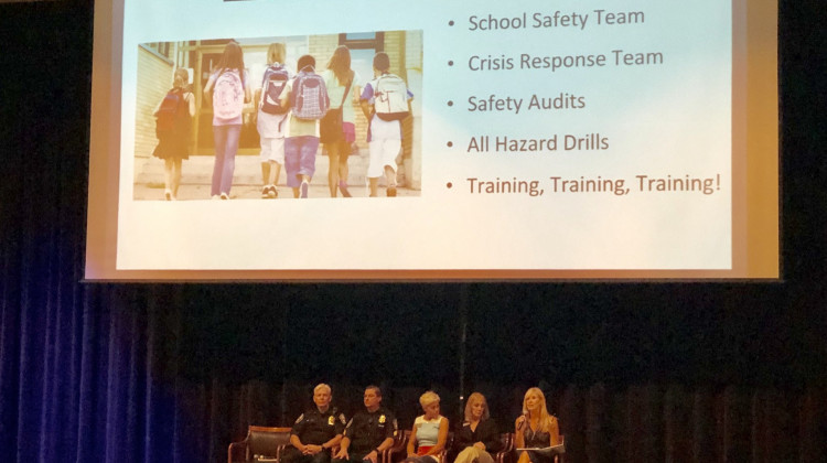 Photo by Carter Barrett. - Carmel Clay High School assistant principals Karen McDaniel and Amy Skeens Benton, and school resource officer D.J. Schoeff talk at the community forum on school safety Aug. 8.