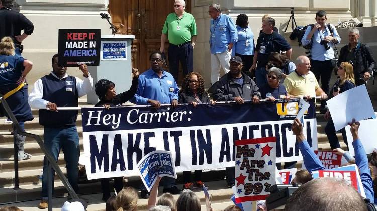 Employees who will lose their jobs at the Indianapolis Carrier factory stood at the front of Friday's rally with union members and Bernie Sanders supporters. - Annie Ropeik/Indiana Public Broadcasting
