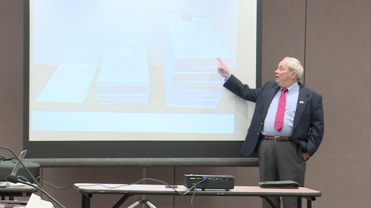 Indiana State Police Forensic Analysis Director Eric Lawrence demonstrates how much case files have grown because of recent changes to how drug crimes are prosecuted.  - Lauren Chapman/IPB News