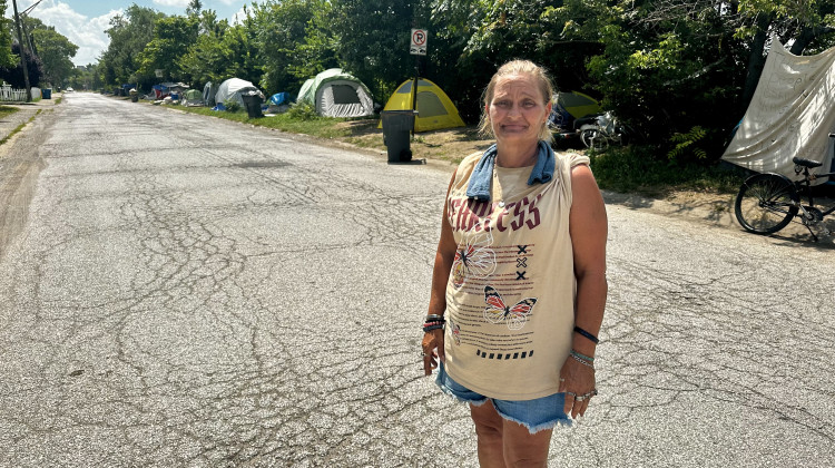 Angela Merrell stands near the camp in Fountain Square on Monday, Aug, 11, 2025. Merrell said she and her husband grew up in the neighborhood. - Zak Cassel / WFYI