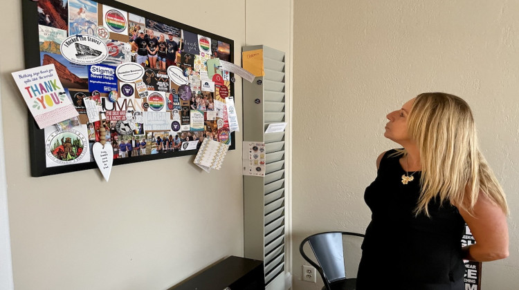 Photo caption 1: Charmin Gabbard looks at a bulletin board in her office at Connection Cafe the Indiana Recovery Network regional recovery hub she runs in Connersville, Indiana.  After she was  released from prison in 2015, Gabbard did not have a drivers  license and struggled to get to.  Gabbard said transportation is a huge barrier for many with a history of substance use. - Darian Benson / Side Effects Public Media