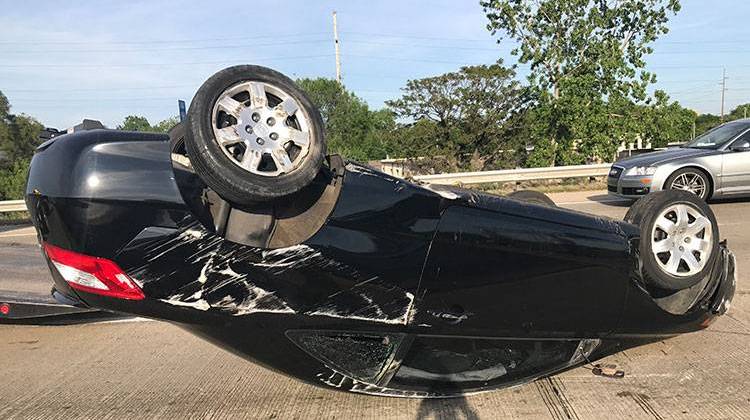 Indianapolis Police Chief Bryan Roach and two concerned citizens helped the driver of this car to safety. The driver's injuries were not expected to be serious.. - IMPD