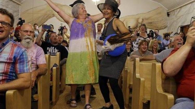 Members of the congregation at the First Church of Cannabis sing and dance during the church's first service, Wednesday, July 1, 2015, in Indianapolis. Church Founder Bill Levin said he decided to keep marijuana out of Wednesday's service to ensure he can test the Indiana religious objections law in civil court instead of on criminal grounds. - The Associated Press