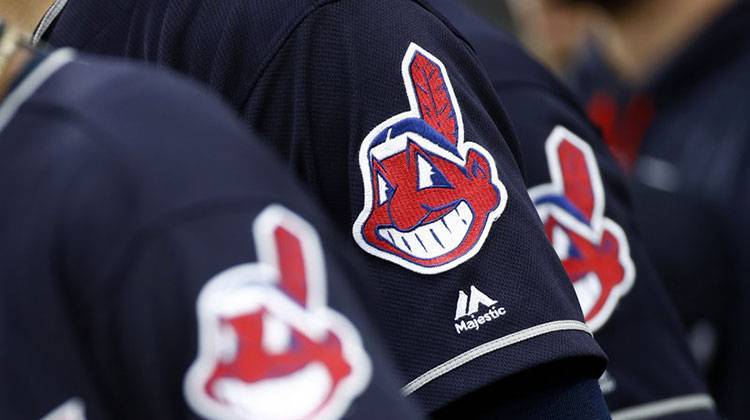 Members of the Cleveland Indians wear uniforms featuring mascot Chief Wahoo as they stand on the field for the national anthem before a baseball game against the Baltimore Orioles in Baltimore in 2017. - AP Photo/Patrick Semansky