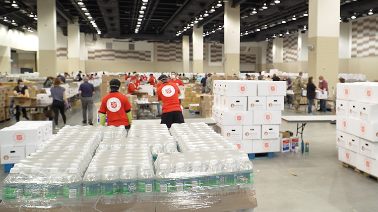 Volunteers from the Salvation Army, Midwest Food Bank, The Indiana National Guard and Lucas Oil Stadium pack food boxes. - Alan Mbathi/IPB News