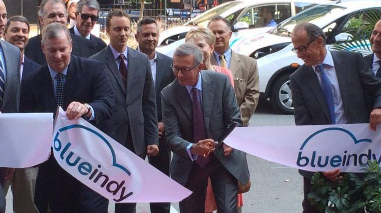 Indianapolis Mayor Greg Ballard (L) and BollorÃ© Group VP CÃ©dric BollorÃ© (C) cut the ribbon signifying the beginning of the BlueIndy program at a ceremony Wednesday morning. - Photo By: Deron Molen