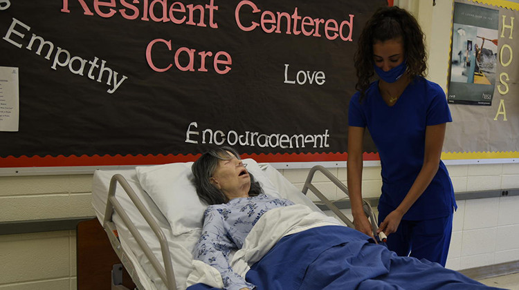Andrea Zaknoun, a CTE student at A.K. Smith Career Center studying to become a certified nursing assistant, practices on a mannequin in a classroom during a Summer Bridge program. - Justin Hicks/IPB News