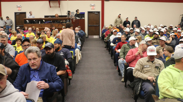 Community members gathered at hearing on an air quality permit for a proposed coal-to-diesel plant in Dale, Indiana. Opponents wore yellow shirts, union workers wore white caps as a show of support. - (Isaiah Seibert/WNIN)