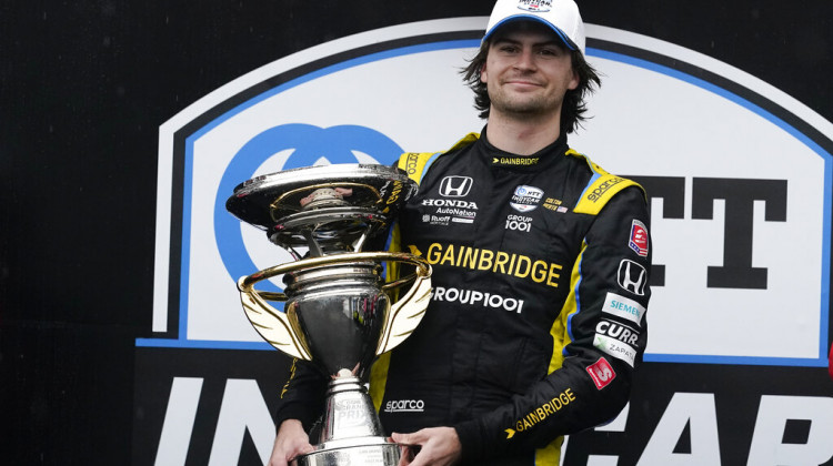 Colton Herta holds the trophy after winning an IndyCar auto race at Indianapolis Motor Speedway, Saturday, May 14, 2022, in Indianapolis. - (Darron Cummings/AP Photo)