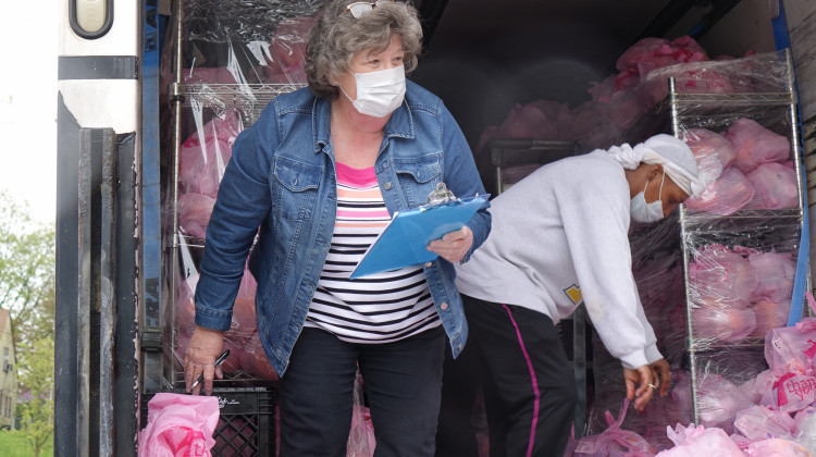 Connie Kristelli, a food service supervisor at Indianapolis Public Schools, stands inside a box truck at James Whitcomb Riley School 43 in April 2020 before families arrive to pick up meals. - Eric Weddle/WFYI News