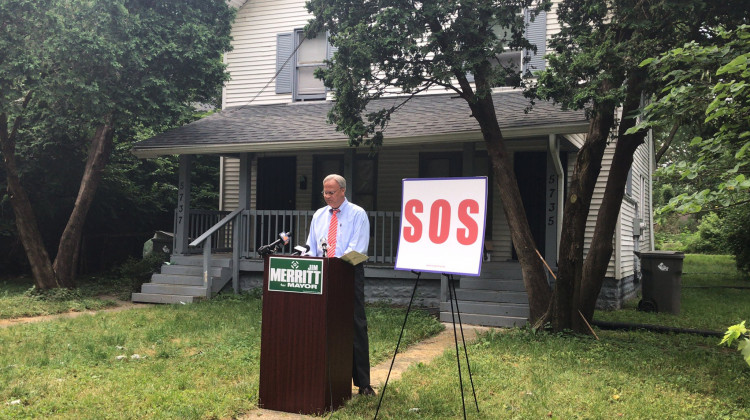 State Senator Jim Merritt speaks in front of a transformed home. - David Wolfe Bender/WFYI