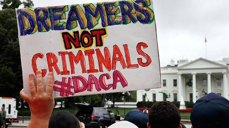 A woman holds up a sign in support of the Obama administration program known as Deferred Action for Childhood Arrivals, or DACA, during a rally at the White House on Aug. 15. - AP Photo/Jacquelyn Martin, File