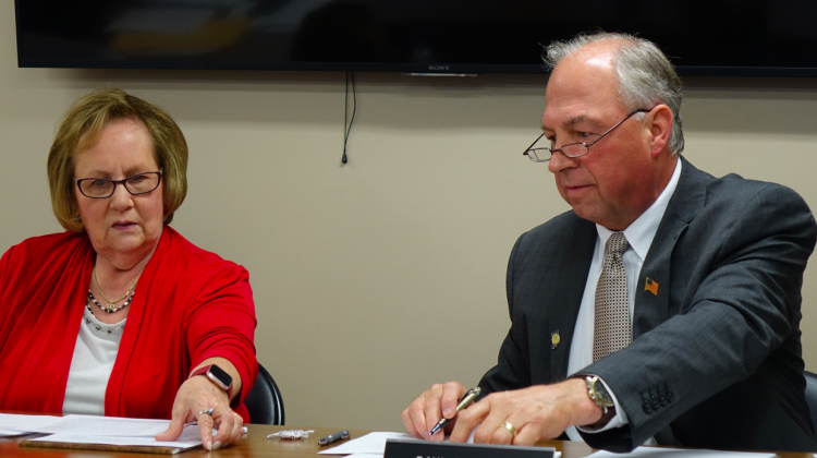 Daleville Community School's Board President Diane Evans, left, and Superintendent Paul Garrison look at documents before the school board votes to close Indiana Virtual School and Indiana Virtual Pathways Academy during a board meeting Monday, Aug. 26, 2019 at the district office. - Eric Weddle/WFYI News