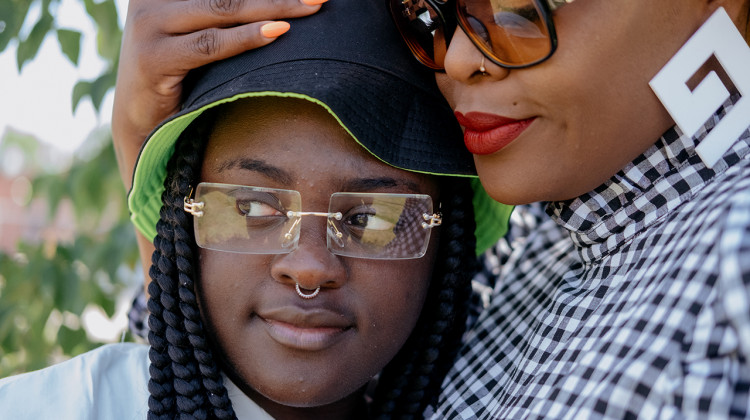 In the national spotlight as a performer with the Detroit Youth Choir, 17-year-old Symone has battled depression for years. She stands here with her mother, Que Jewelz, at their Highland Park home in Michigan. - (Erin Kirkland/Bridge Michigan)