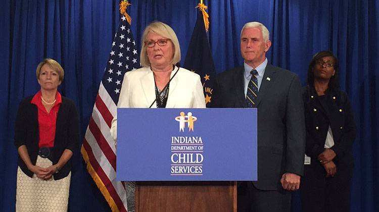 DCS Director, Mary Beth Bonaventura speaks to reporters as Lt. Gov. Sue Ellspermann; Gov. Mike Pence; and DCS Chief of Staff, Doris Tolliver look on. - Brandon Smith