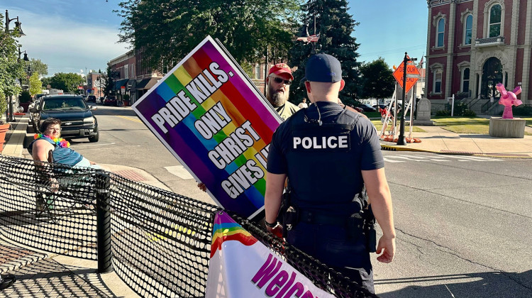 A protestor holds a sign outside the Decatur Pride event in downtown Decatur on Saturday, June 28. 2025. - Zak Cassel / WFYI
