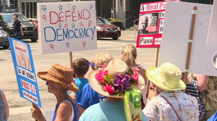 Demonstrators gathered in front of U.S. Sen. Todd Young (R-Ind.)'s office before marching to the office of U.S. Sen. Mike Braun (R-Ind.) a few blocks away.  - Lauren Chapman/IPB News