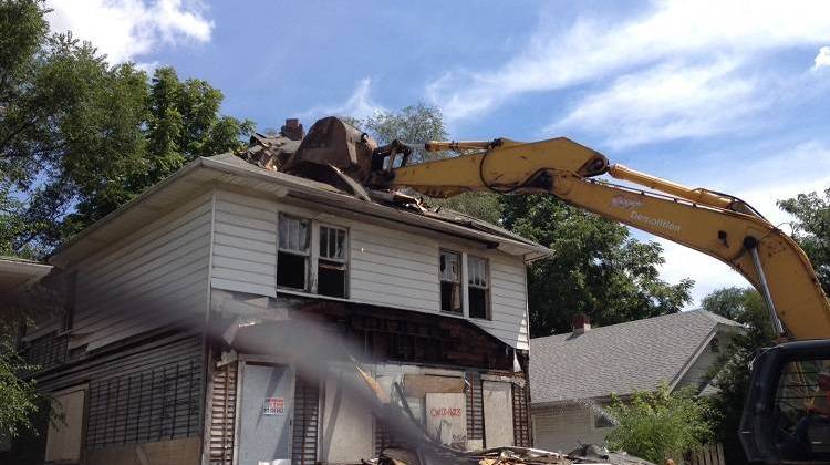 This house at 253 N. Oxford Street sat abandoned for at least 10 years before a demolition crew did its work on Monday, August 8, 2016 - WFYI photo by Michelle Johnson