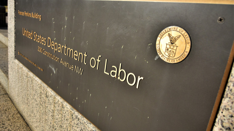 A placard in front of the U.S. Department of Labor. A proposed mandate would have Occupational Safety and Health Administration enforce a requirement that businesses with 100 or more employees be vaccinated or get tested weekly. - Justin Hicks/IPB News