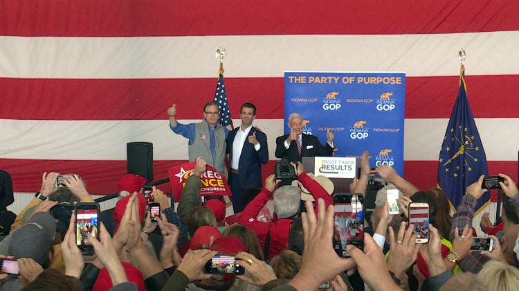 Donald Trump Jr., center, rallies in Greenfield, Indiana, with Republican Senate candidate Mike Braun, left, and 6th Congressional District candidate Greg Pence, right. - (Lauren Chapman/IPB News)
