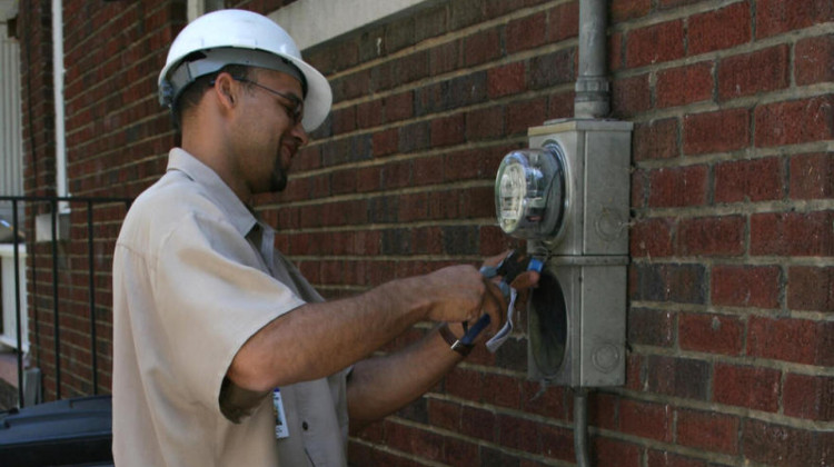 A Duke Energy technician disconnecting electricity at a residence due to nonpayment in North Carolina, 2008.  - Ildar Sagdejev/Wikimedia Commons