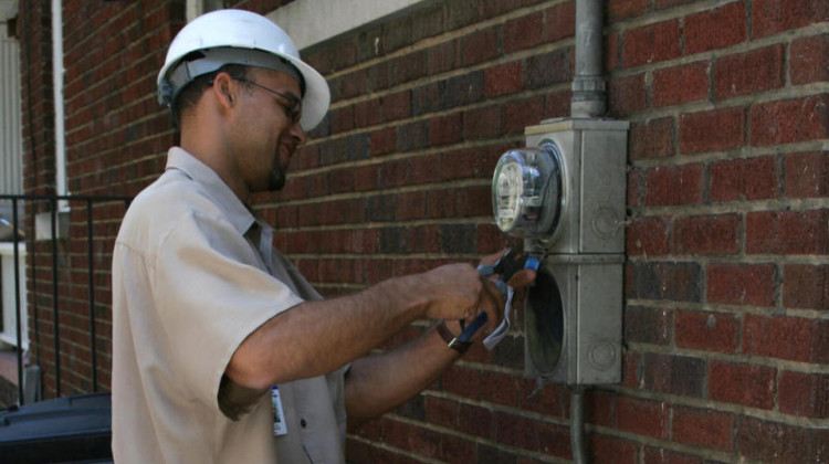 A Duke Energy technician disconnecting electricity at a residence due to nonpayment in North Carolina, 2008. - Ildar Sagdejev/Wikimedia Commons