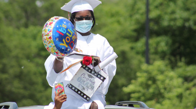 Students from Emmerich Manuel High School in Indianapolis received their diplomas and gifts during a drive-thru ceremony on Saturday, May 30.  - Lauren Chapman/IPB News