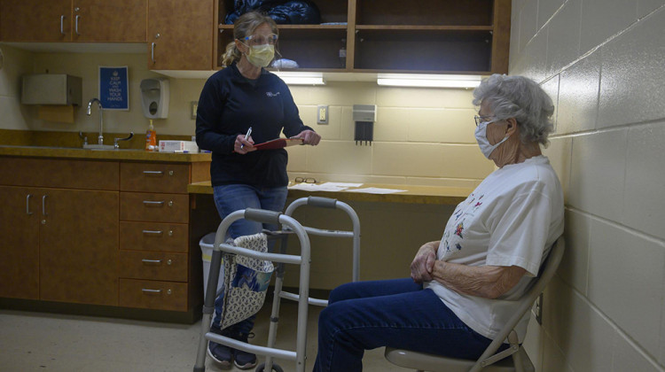 Nurse Tammy Miller asks Beverly Gerard, 92, of Beverly, Iowa, questions before administering her first dose of the Moderna COVID-19 vaccine on Feb. 1. Gerard secured an appointment at the Tama County Public Health Department clinic in through her niece. - Natalie Krebs/Side Effects Pubic Media