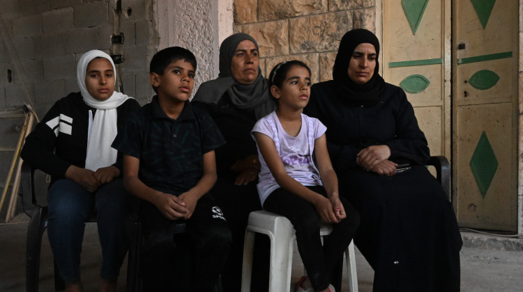 The family of Bilal Muhammed Saleh outside their home in  As-Sawiya, occupied West Bank on Oct. 31, 2023. - Tanya Habjouqa / NOOR for NPR