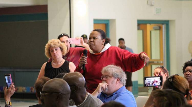 n East Chicago resident testifies at a federal public hearing on the plan to demolish West Calumet Housing Complex, as a Housing and Urban Development Official (left, in black) looks on. - Annie Ropeik/IPB News