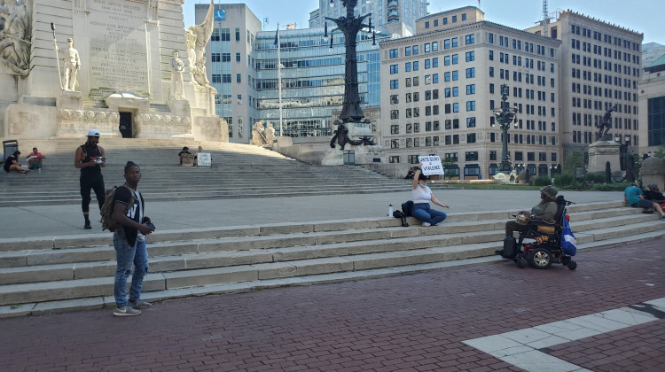 A small group of protesters gathers at Monument Circle Friday evening. - Samantha Horton/IPB News