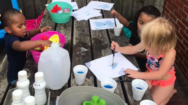 A group of children engage in water play at Care Bear Child Care Inc., a home day care in Indianapolis owned by LiTrina Hobbs. - LiTrina Hobbs