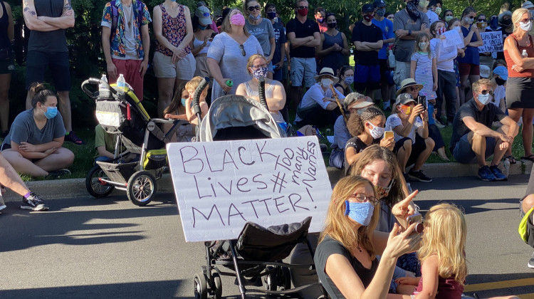 Hundreds gathered Sunday evening for a community prayer event in the Butler-Tarkington neighborhood.   - Darian Benson/Side Effects Public Media