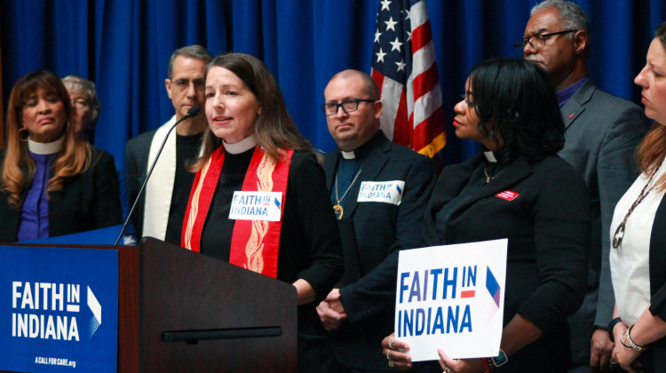 Rev. Dr. Sarah Griffith Lund, at lectern, speaks about the importance of mental health crisis response services at a Statehouse press conference on Tuesday, Mar. 7, 2023. Behind her are fellow faith leaders, part of the advocacy group Faith In Indiana.  - Brandon Smith/IPB News