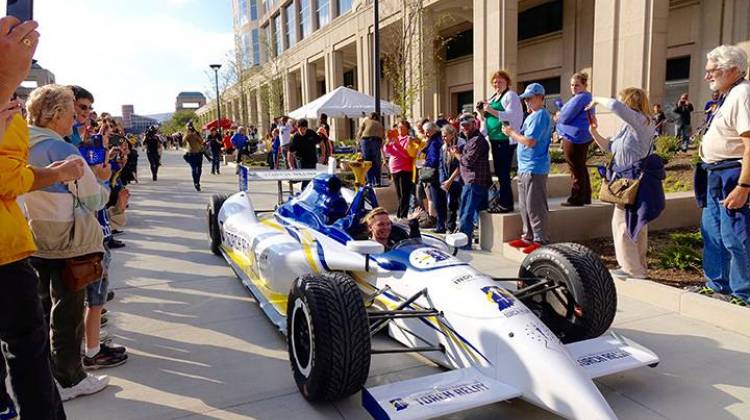 Retired IndyCar driver Sarah Fisher navigates the final leg of the Bicentennial Torch Relay through a crowd at the Indiana Statehouse Saturday, October 15, 2016.  - Michelle Johnson / WFYI