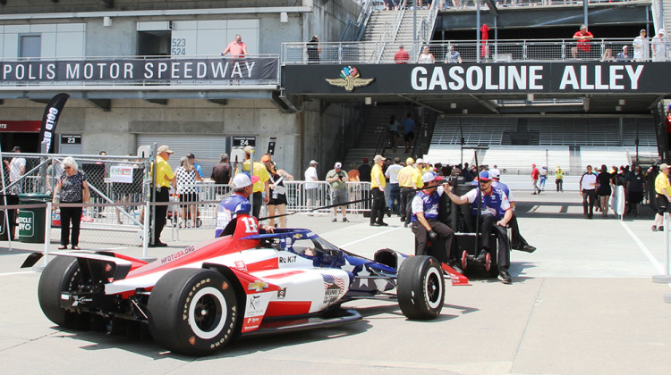 Crew members tow JR Hildebrand's car from the garages to pit lane ahead of practice session for the Indianapolis 500 on Friday, May 22. - Doug Jaggers/WFYI