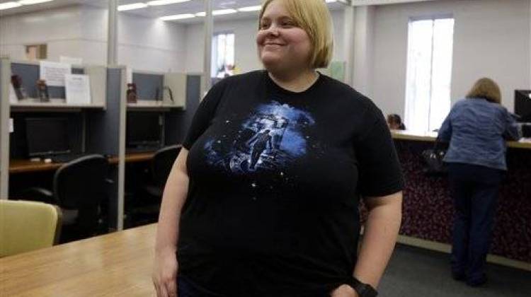 Katie Burris waits in the Marion County Clerks office fork the arrival of her partner Evangeline Cook so the couple could apply for a marriage license in Indianapolis, Monday, Oct. 6, 2014. - The Associated Press
