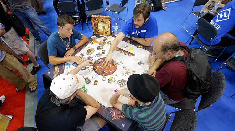 Gamers play a game of Mission: Red Planet in the exhibition hall at the Gen Con gaming convention in Indianapolis, Thursday, July 30, 2015. - AP Photo/Michael Conroy