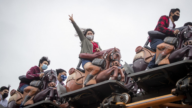To mask or not to mask: That is the question for vaccinated people as the delta variant surges. The answer may depend on the situation, experts say. Here, these roller-coaster riders mask up at Knott's Berry Farm in Buena Park, Calif. - (Allen J. Schaben/Los Angeles Times via Getty Images)