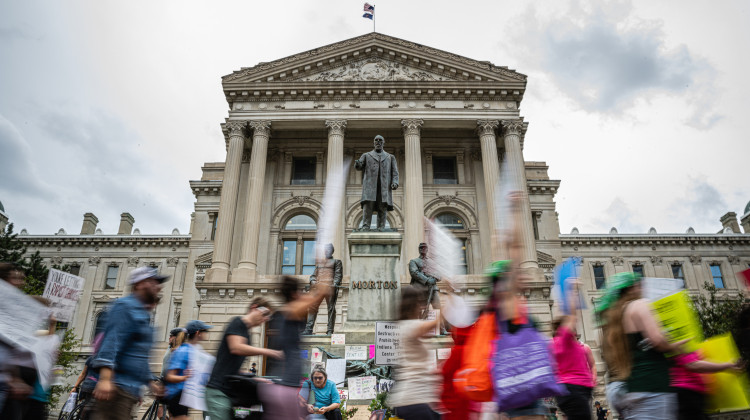 Protesters march outside the Indiana state Capitol building on July 25, 2022, in Indianapolis as activists gathered during a special session. - Jon Cherry / Getty Images