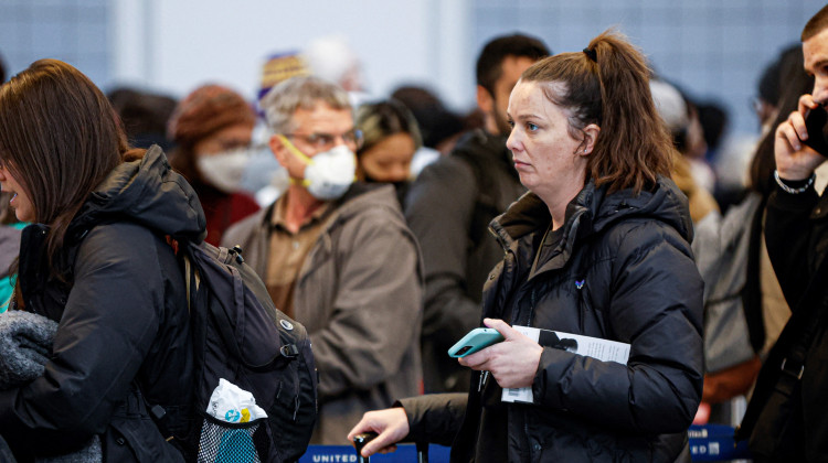 Travelers wait in line for their security screening at O'Hare International Airport on Dec. 22 in Chicago. - Kamil Krzaczynski / AFP via Getty Images