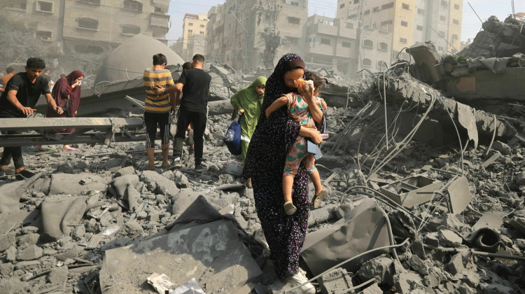 Palestinians evacuate the area following an Israeli airstrike on the Sousi mosque in Gaza City on October 9, 2023. Images of suffering, violence and death in Gaza and Israel have flooded the news since Oct. 7. - MAHMUD HAMS / AFP via Getty Images