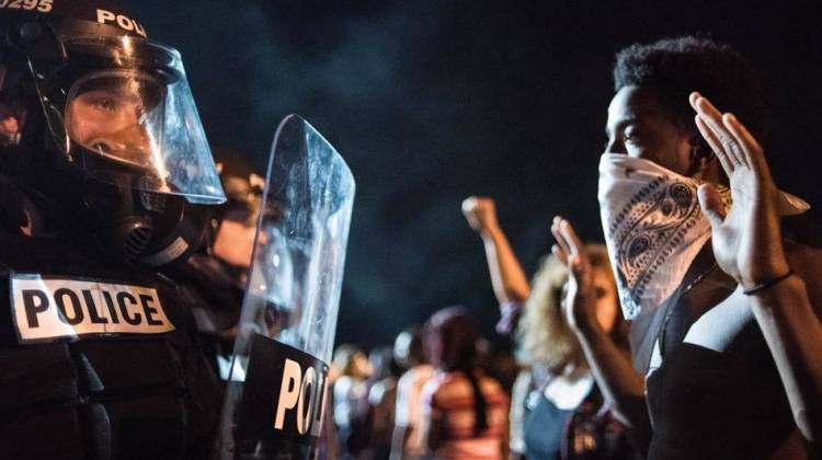 Police officers face off with protesters on Interstate 85 in Charlotte, N.C., during demonstrations following the death of a man shot by a police officer on Tuesday.