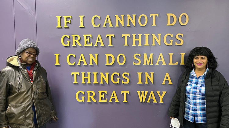 Ethel McFarland (left) and Carmen Helms (right) stand in front of a quote by Dr. Martin Luther King, Jr. on a wall inside the Frederick Douglass Family Center.  - Jill Sheridan/WFYI