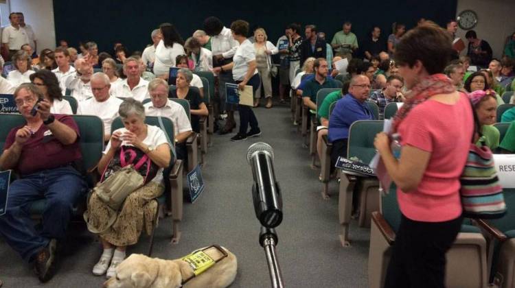 In the Lafayette City Council chambers, supporters of the ordinance wore green and opponents white, and were split down the aisle at Tuesday's meeting. - Sarah Fentem