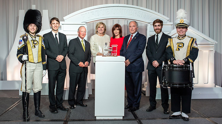 Marc and Sharon Hagle (third and fourth from right), with Purdue trustee Vanessa Castagna, Purdue President Mitch Daniels, and students from Purdue Bands & Orchestras. - New Frame Photography