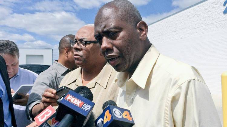 Rev. Charles Harrison, right, speaking after a community meeting with Indianapolis police command. - Ryan Delaney/WFYI